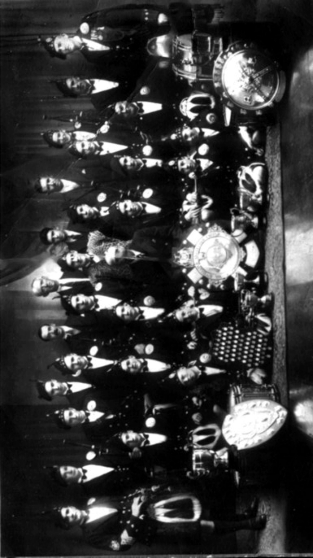 Overhead aerial view of Allandale Pipe Band with complete collection of 1938 championship trophies and 72 medals displayed